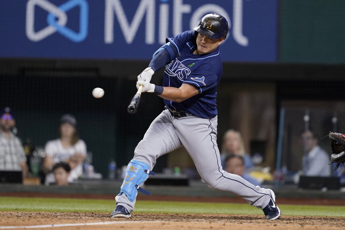 Tampa Bay Rays' Ji-Man Choi hits an RBI double against the Texas Rangers during the 11th inning of a baseball game Wednesday, June 1, 2022, in Arlington, Texas. (AP Photo/Tony Gutierrez)