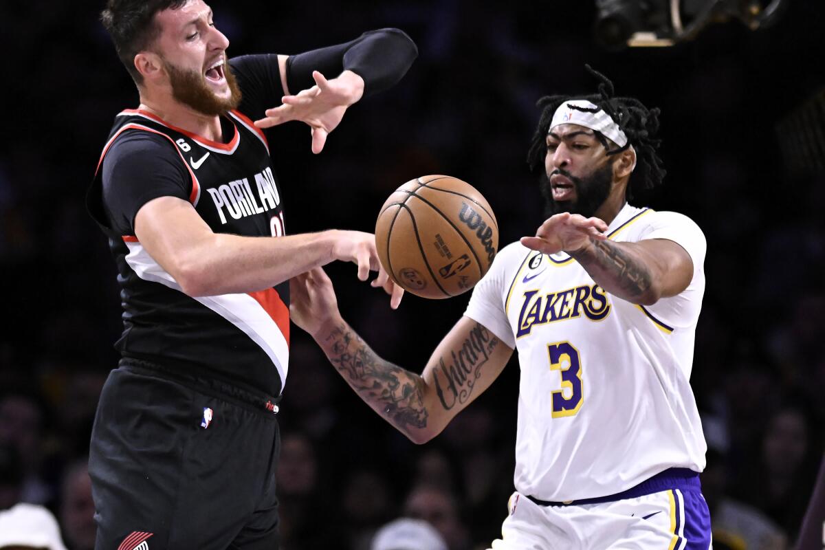 Lakers forward Anthony Davis, right, strips the ball from Portland Trail Blazers center Jusuf Nurkic during the first half.