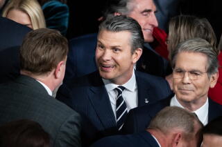 Defense Secretary Pete Hegseth, center, arrives in the House Chamber of the U.S. Capitol