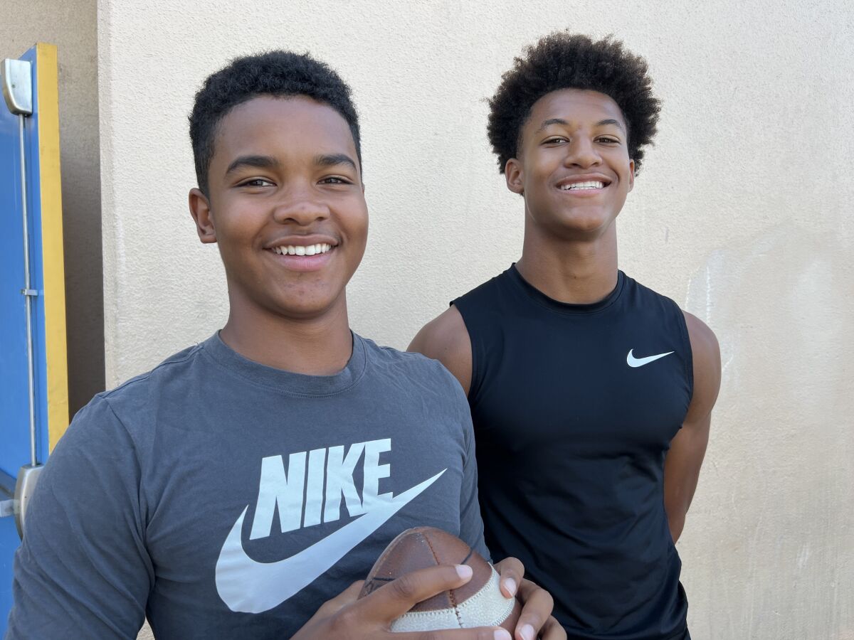 Sophomore quarterback Kingston Tisdell and junior receiver/cornerback Peyton Waters pose for a photo