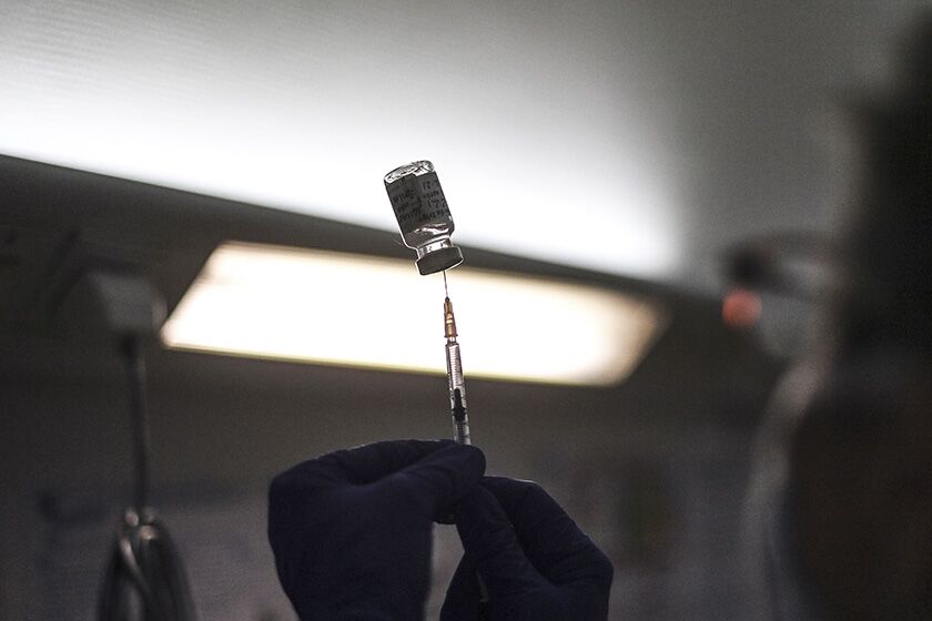 A nurse prepares a dose of the AstraZeneca COVID-19 vaccine in Lyon, France.