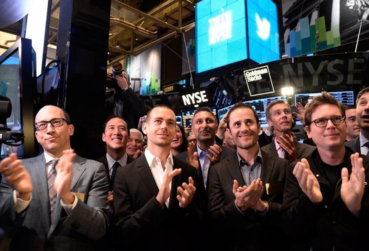 Twitter executives applaud as trading in the company's stock begins at the New York Stock Exchange last month. Twitter shares topped $50 in midsession trading Tuesday.