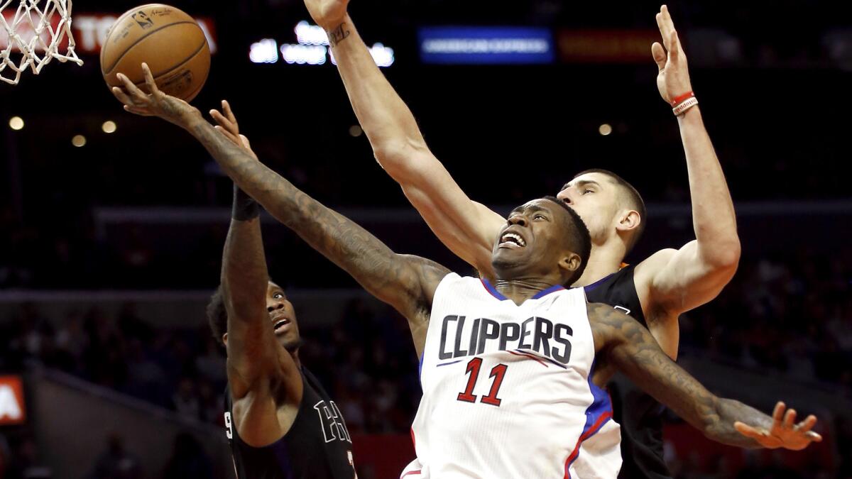 Clippers guard Jamal Crawford drives to the basket for a layup against PSuns guard Eric Bledsoe, left, and center Alex Len during the second half Monday.
