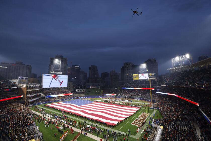San Diego CA - December 27: A Coast Guard helicopter does a fly over during the national anthem before USC played Louisville in the Holiday Bowl at Petco Park on Wednesday, December 27, 2023 in San Diego, CA. (K.C. Alfred / The San Diego Union-Tribune)