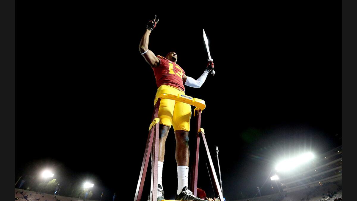 USC receiver De'Quan Hampton leads the marching band after the Trojans' 36-14 victory over the Bruins at the Rose Bowl on Nov. 19.