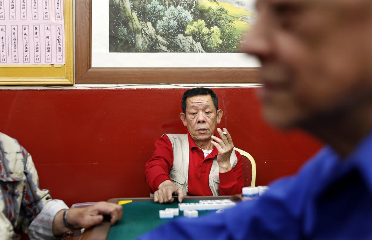Seniors play mahjong at Hop Sing Tong Benevolent Association in Chinatown