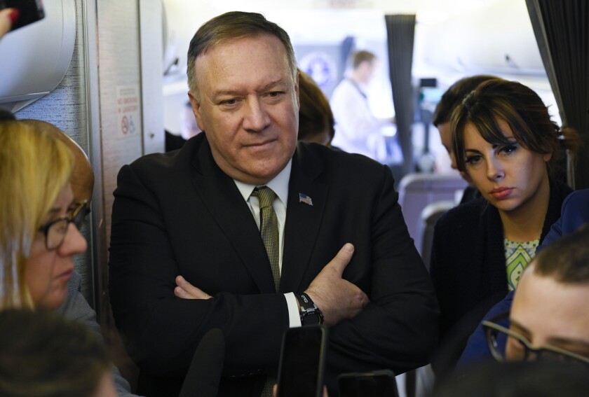 Secretary of State Mike Pompeo takes questions from reporters during a flight from Andrews Air Force Base, Md., to Germany, Thursday, February 13, 2020. Pompeo on Thursday said he is “outraged” by the U.N.'s publication of a list of companies accused of violating Palestinian human rights by operating in Israel's West Bank settlements. (Andrew Caballero-Reynolds/Pool via AP)