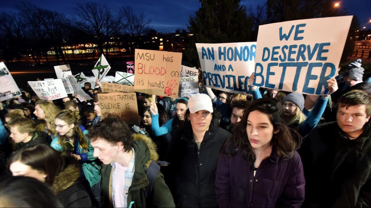 Demonstrators gather at Michigan State University's East Lansing, Mich., campus to support victims of disgraced former sports doctor Larry Nassar and call for more changes in leadership at the school.