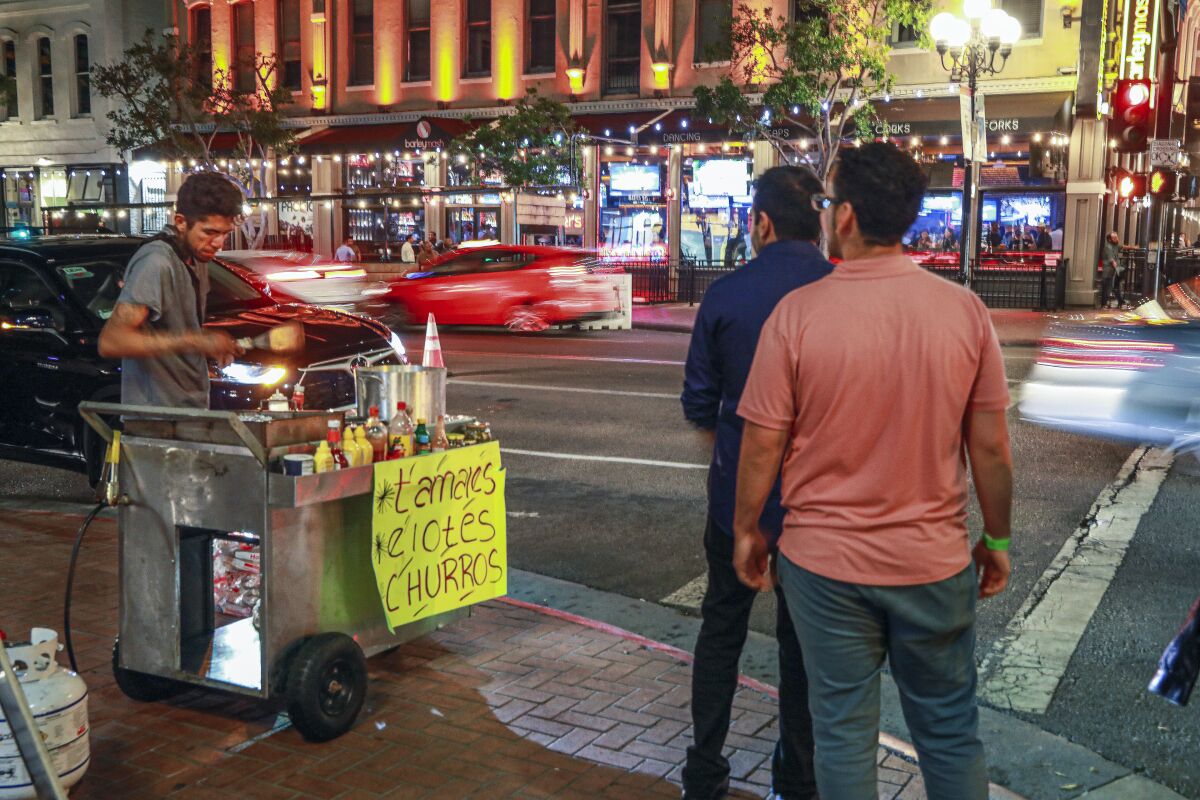 A street vendor sells food along 5th avenue and Market Street in the Gaslamp Quarter on August 27, 2021.