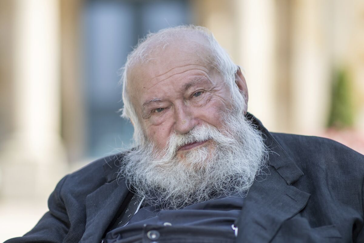 FILE -Action artist Hermann Nitsch sits in front of the Festspielhaus in Bayreuth, Germany, July 23, 2021. Nitsch, an Austrian avant-garde artist who was known among other things for “Action" paintings created with animal blood and entrails, has died. (Daniel Karmann/dpa via AP,file)