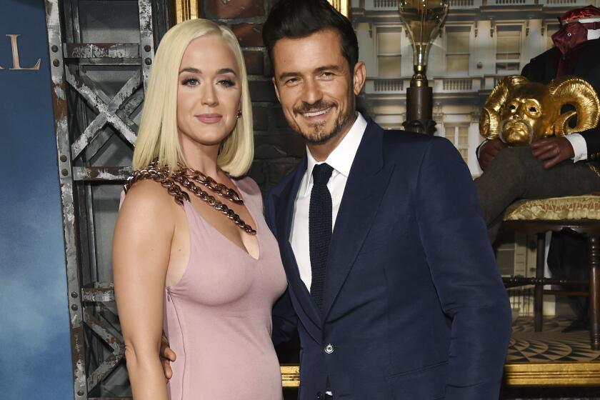 FILE - This Aug. 21, 2019 file photo shows Orlando Bloom, right, a cast member in the Amazon Prime Video series "Carnival Row," with singer Katy Perry, at the premiere of the series in Los Angeles. Perry has given birth to a baby girl named Daisy Dove Bloom. The pop superstar and her partner, actor Orlando Bloom, got UNICEF to announce the news on its Instagram account. Both Perry and Bloom are goodwill ambassadors for the United Nations agency that helps children. (Photo by Chris Pizzello/Invision/AP, File)