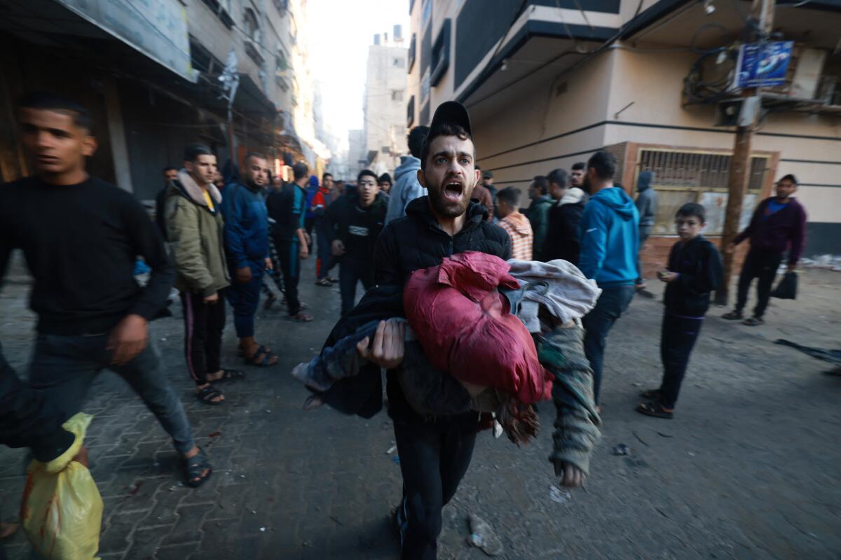 People run for cover following the resumption of Israeli bombardment in Rafah in the southern Gaza Strip.