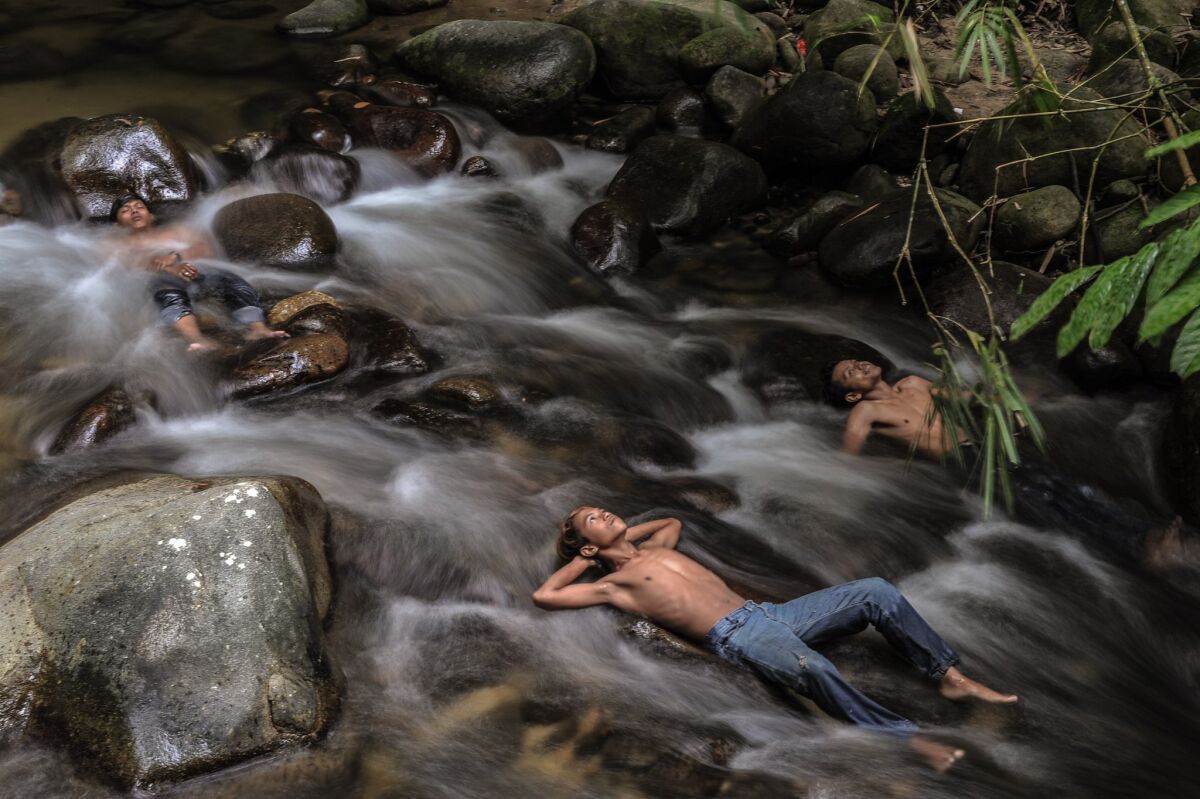Malaysian youths cool off in a river as schools remain closed due to hazy conditions in Hulu Langat. Malaysia, Singapore and large expanses of Indonesia have suffered for weeks from acrid smoke billowing from fires on Indonesian plantations and peatlands.