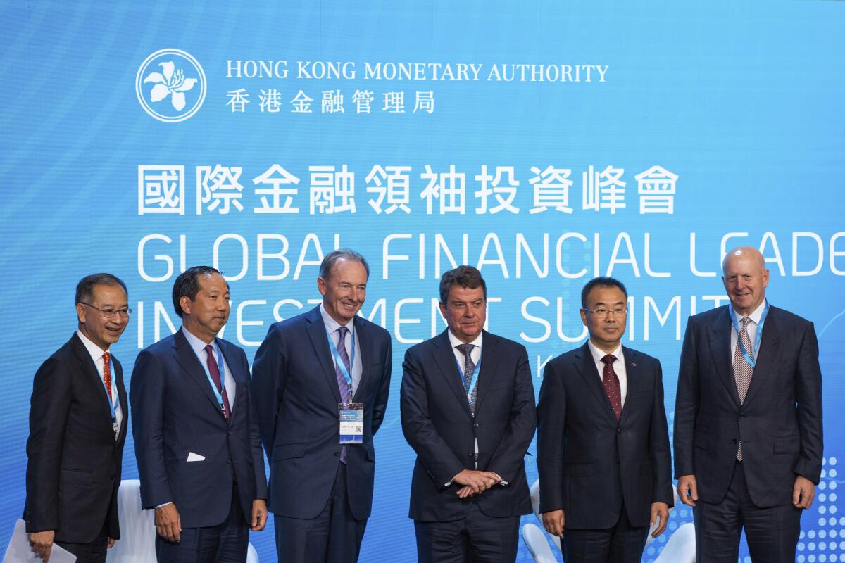 From left; Chief Executive of the Hong Kong Monetary Authority Eddie Yue, CFO and Senior Managing Director of Blackstone Michael Chae, Chairman and CEO of Morgan Stanley James Gorman, Chairman of UBS Group AG Colm Kelleher, President of Bank of China Liu Jin, Chairman and CEO of Goldman Sachs David Solomon pose during the Global Financial Leaders' Investment Summit in Hong Kong, Wednesday, Nov. 2, 2022. Chinese regulators downplayed China's real estate slump and slowing economic growth while Hong Kong's top leader pitched Hong Kong as a unique link to the rest of China at a high-profile investment summit Wednesday. (AP Photo/Bertha Wang)