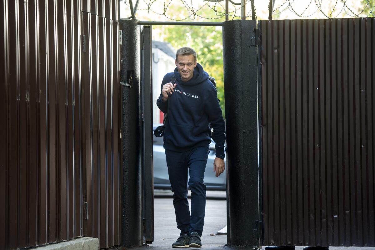Russian opposition leader Alexei Navalny leaves a detention center after his release, in Moscow, Russia, Friday, Aug. 23, 2019. Navalny, the Kremlin's most prominent foe, was sentenced last month to 30 days for calling on people to take part in an unauthorized protest. (AP Photo/Dmitry Serebryakov)
