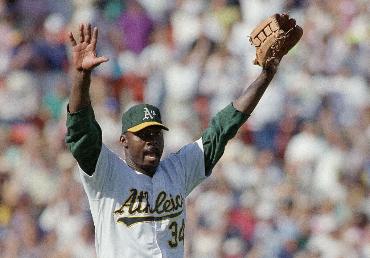 FILE - Oakland Athletics pitcher Dave Stewart celebrates the team's 6-2 victory over the Toronto Blue Jays in Game 5 of baseball's AL Championship Series on Oct. 12, 1992, in Oakland, Calif. Stewart is still waiting for his number retirement ceremony. Stewart, now 65, found out in August 2019 the club planned to retire his No. 34 jersey, then it didn’t happen during the pandemic-shortened 2020 season or last year. The former World Series MVP and four-time 20-game winner posted on his Twitter account this week some frustration with his hometown team. (AP Photo/Eric Risberg, File)