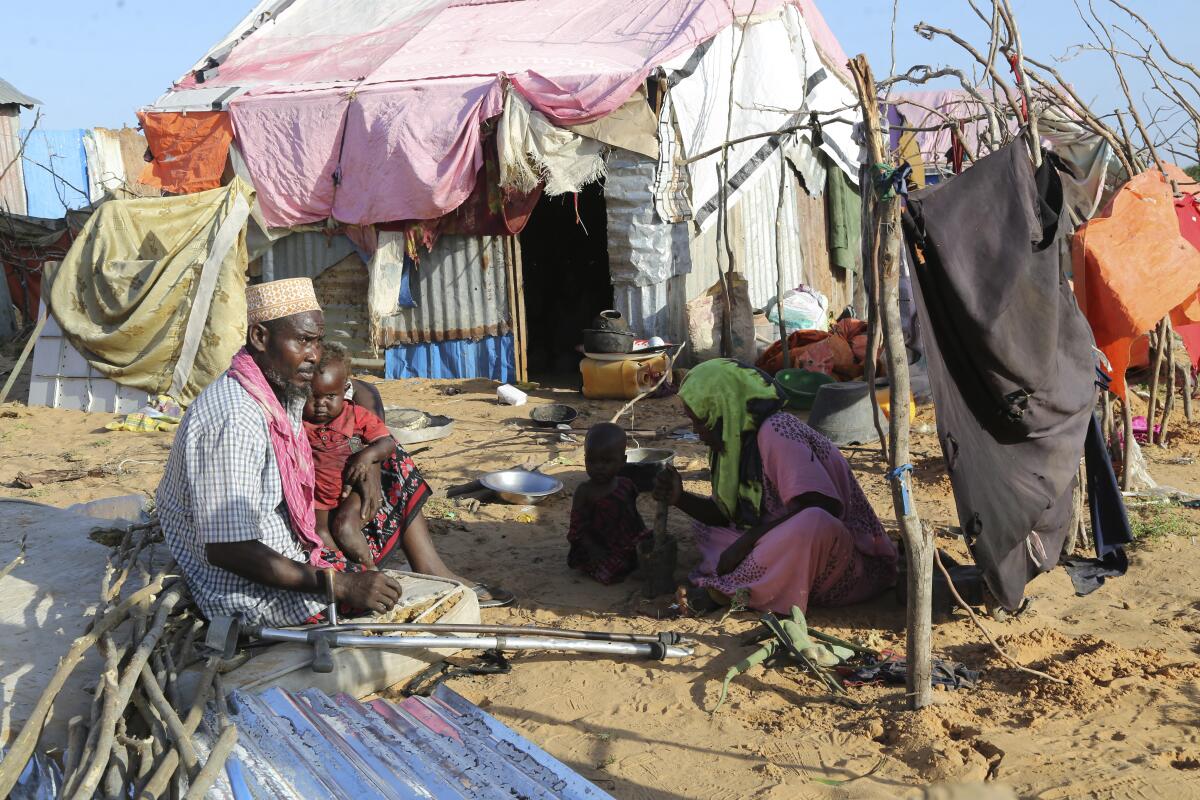 Hassan Mohamed Yusuf with his family at their makeshift shelter in Mogadishu, Somalia.  