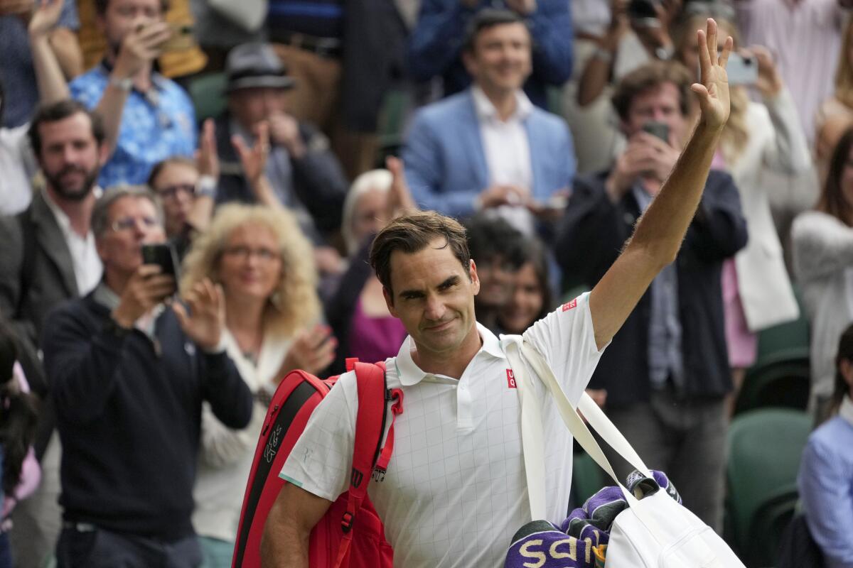 Roger Federer waving to fans on Centre Court at Wimbledon