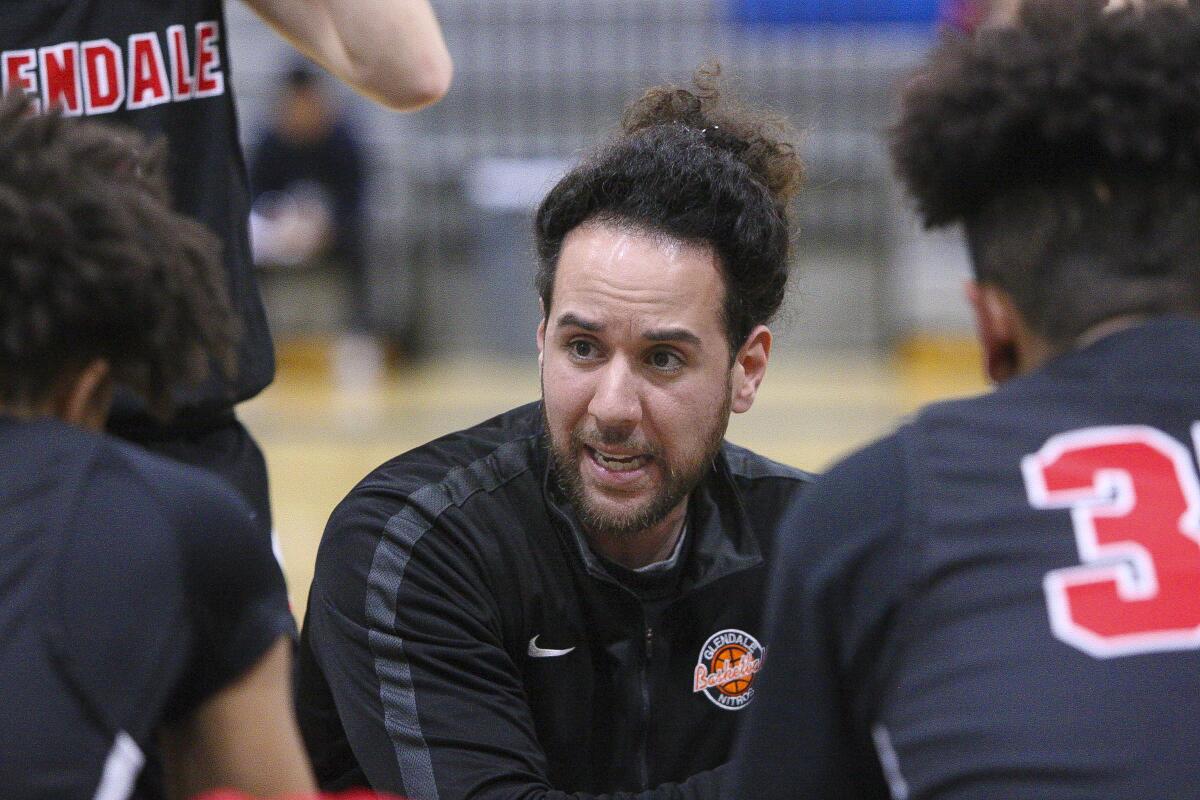 Glendale's head coach Ib Belou talks with his team during halftime against Burbank in a Pacific League boys' basketball game at Burbank High School on Friday, January 17, 2020.