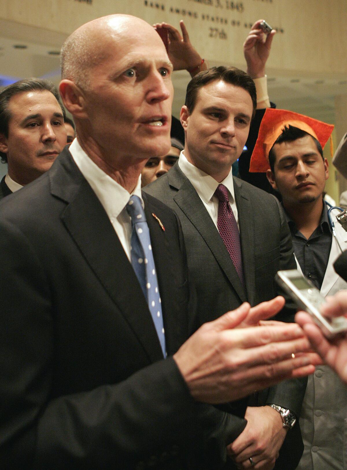Gov. Rick Scott speaks at a news conference. Scott received an election-year boost when the state Senate passed legislation Thursday that would allow the children of immigrants in the country illegally to pay in-state tuition rates to state colleges.