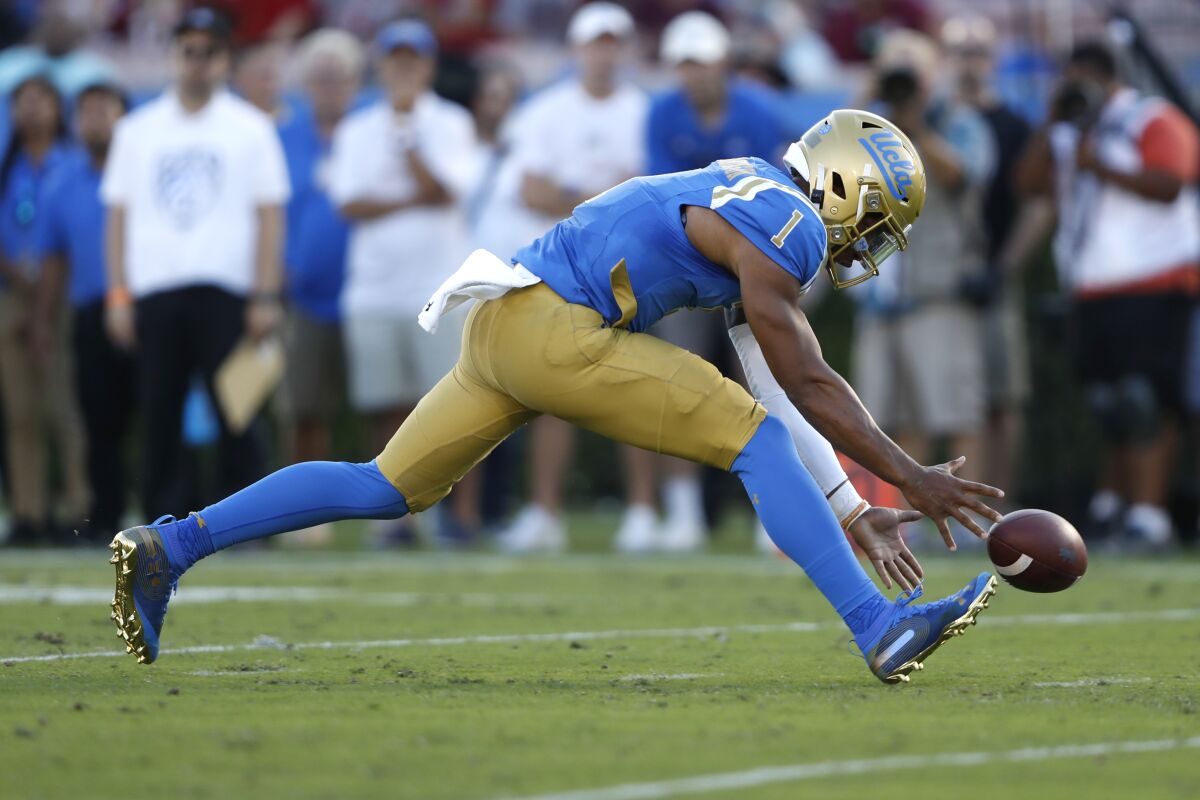 UCLA quarterback Dorian Thompson-Robinson chases a high snap during the first half of Saturday's loss to Oklahoma at the Rose Bowl.
