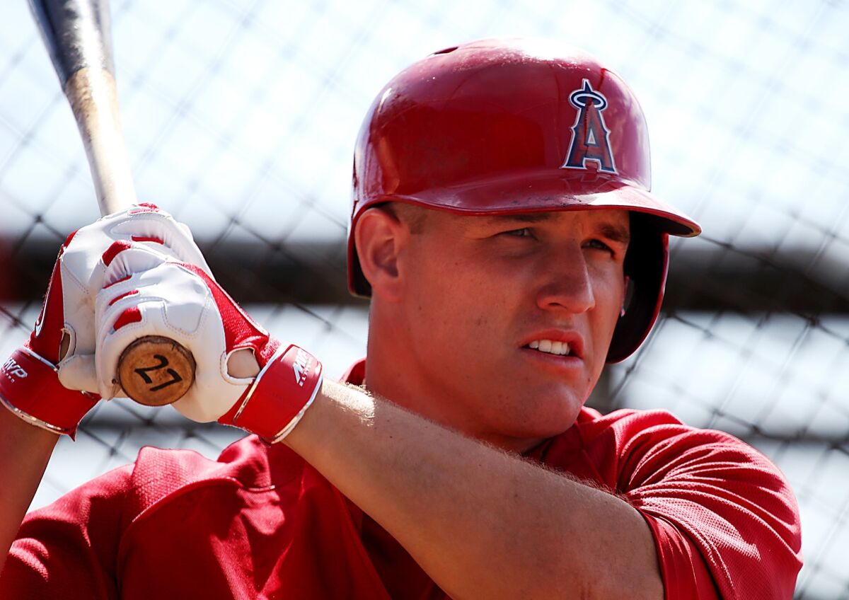 Mike Trout will be examined by a doctor Wednesday in Houston after leaving the Angels' 7-2 loss to the Astros because of back discomfort. The outfielder had missed the Angels' last two games with back stiffness.