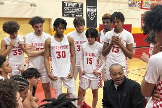 Taft coach Derrick Taylor talks to his team during timeout Fridiay night against King/Drew