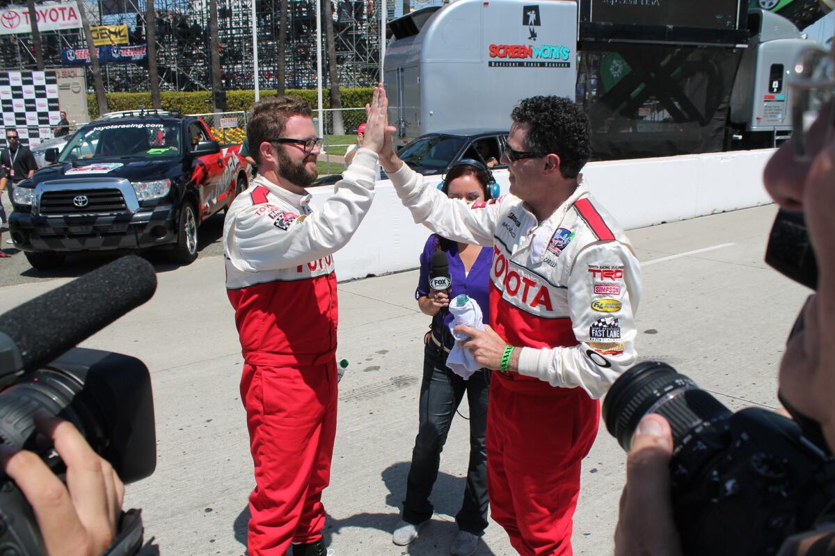 Rutledge Wood, left, and Adam Carolla celebrate after winning their respective classes in the Toyota Pro/Celebrity race at the 2013 Long Beach Grand Prix.