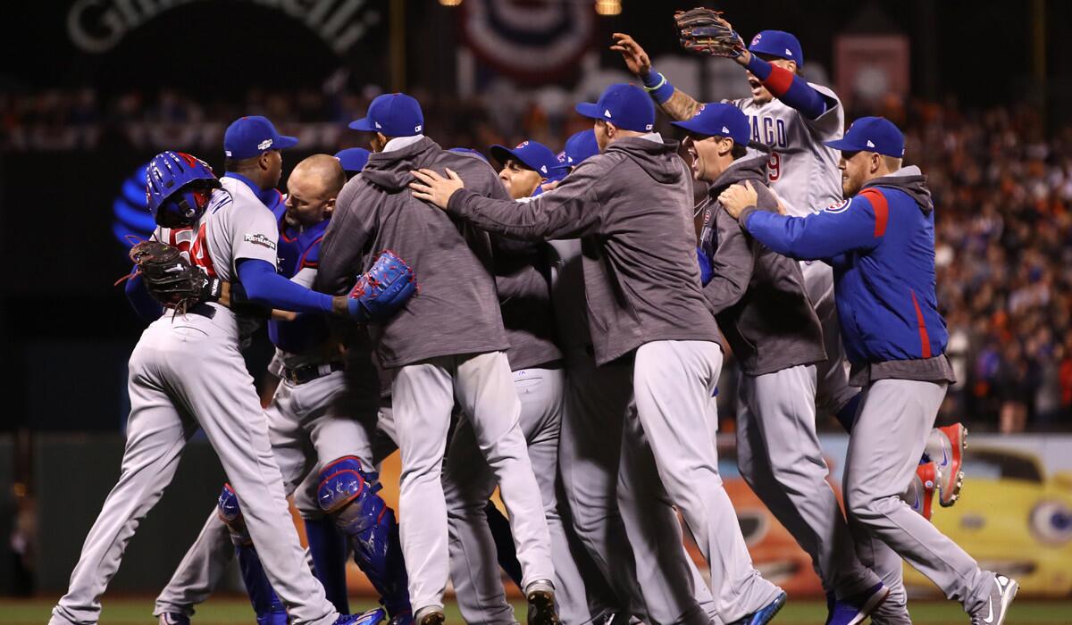 The Chicago Cubs celebrate after defeating the San Francisco Giants 6-5 in Game Four of the NLDS to advance to the National League Championship Series.