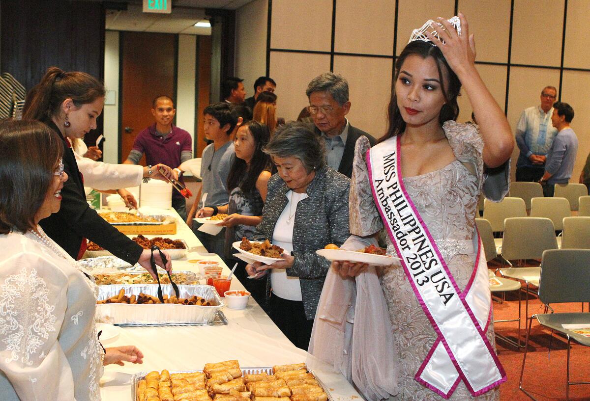 Miss Philippines USA Ambassador 2013 Camille Teodoro, of Los Angeles, at a celebration of Philippine Heritage - Arts and Culture at the Glendale Library on Friday, October 11, 2013. Several certificates were given, food served, and arts displayed at the event, attended by about 60 people.