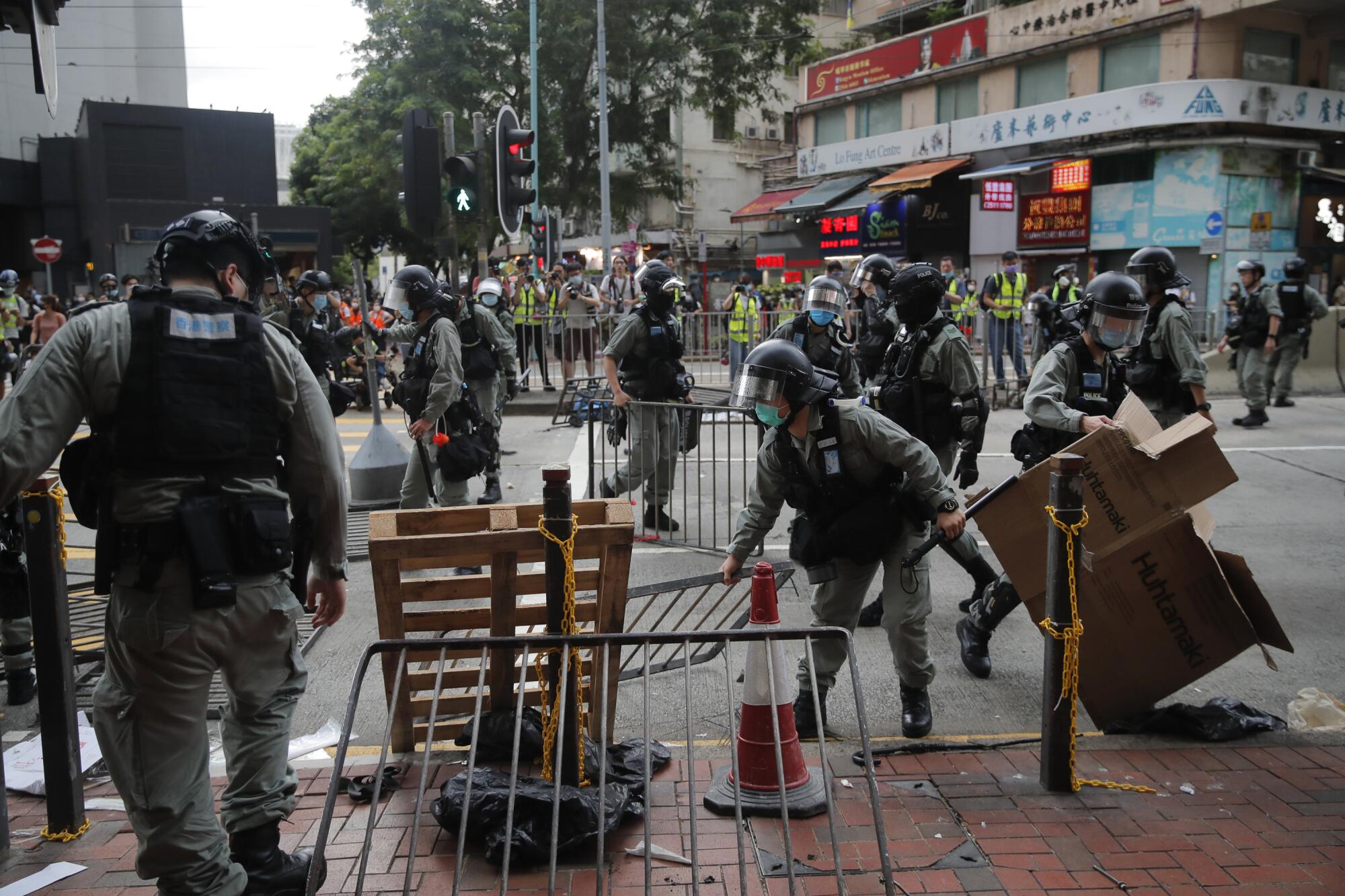 Riot police clear a road after pushing back security law protesters in Hong Kong on Wednesday.