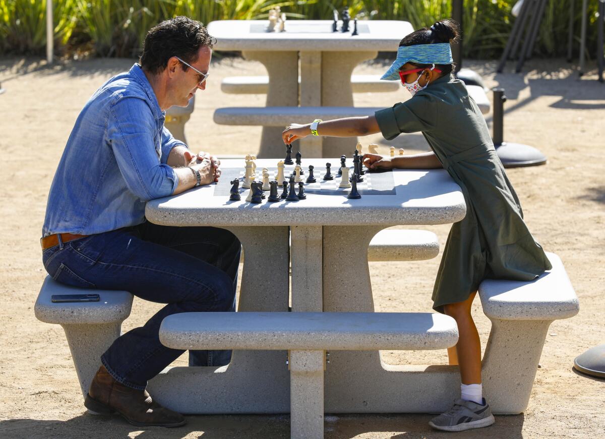 County Supervisor Nathan Fletcher (left) plays chess with Dhwani Bharbwaj, 8, at Waterfront Park