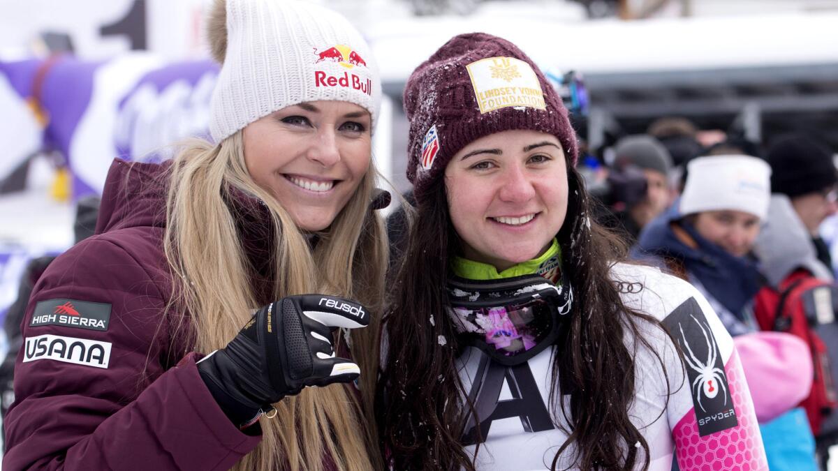 Lindsey Vonn, left, and Jacqueline Wiles pose for photos after competing in a World Cup downhill race Sunday.