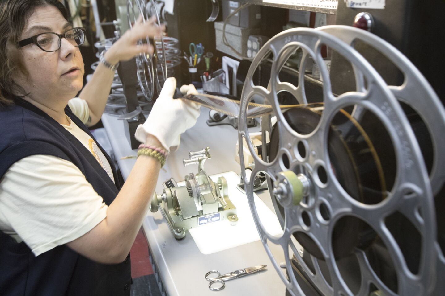 Projectionist Gariana Abeyta inspects a film reel at the New Beverly Cinema.
