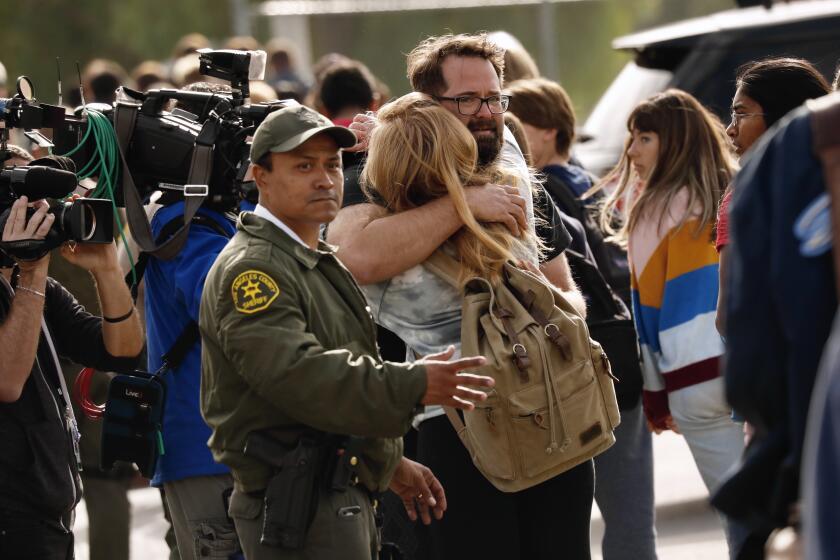 SANTA CLARITA CA NOVEMBER 14, 2019 -- Parents are reunited with their kids at Saugus High School, where a shooting Thursday morning left 1 dead, at least four others wounded on the Santa Clarita campus, November 14, 2019. (Al Seib / Los Angeles Times)