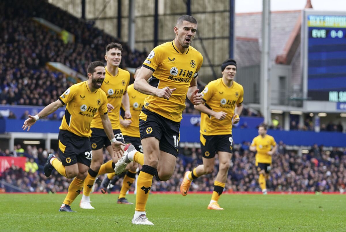 Wolverhampton Wanderers' Conor Coady celebrates scoring their side's first goal of the game during their English Premier League soccer match against Everton at Goodison Park, Liverpool, England, Sunday, March 13, 2022. (Martin Rickett/PA via AP)