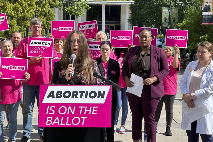 Planned Parenthood Votes South Atlantic spokesperson, Emily Thompson, announces a $10 million investment into a state voter engagement campaign at a press conference in Bicentennial Plaza in Raleigh, N.C., on Thursday, April 25, 2024. The campaign will focus on canvassing, mailers, digital ads and phone banking to block a GOP legislative supermajority and Republican governor in the 2024 election. (AP Photo/Makiya Seminera)