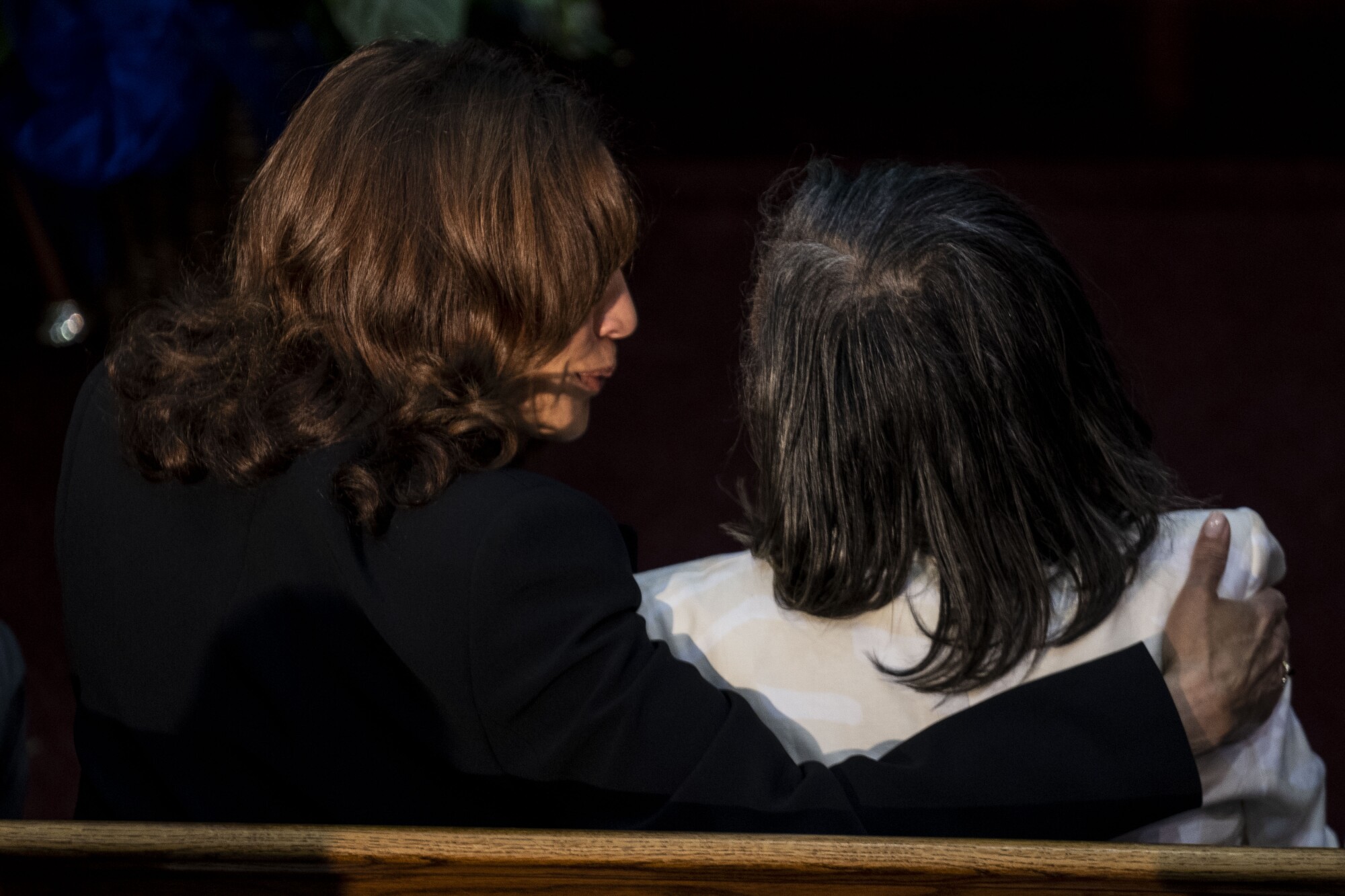 Kamala Harris speaks to woman at funeral.