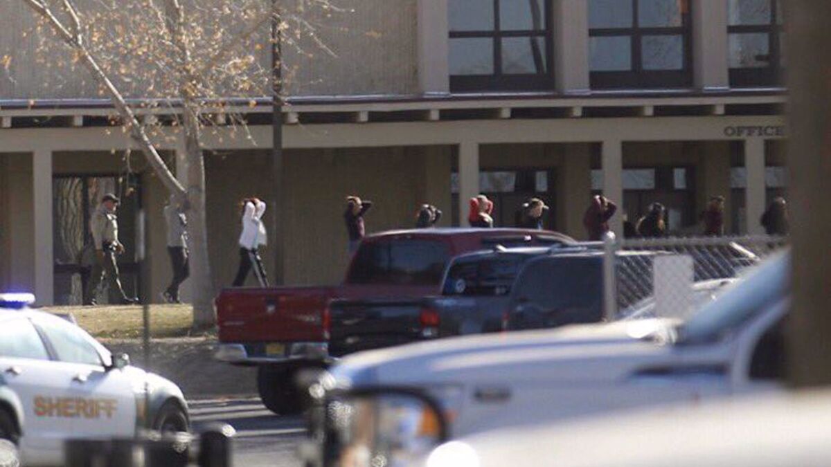 Students are led out of Aztec High School after a shooting Thursday, Dec. 7, 2017, in Aztec, N.M.
