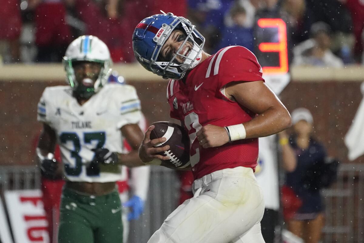 Mississippi quarterback Matt Corral tilts his head as he celebrates his touchdown run against Tulane.