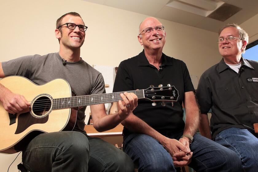 Taylor Guitars luthier Andy Powers alongside Taylor co-founders Bob Taylor (center) and Kurt Listug.