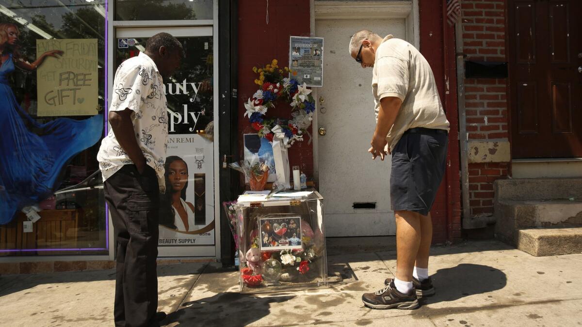 Mourners stop to pray at the memorial site for Eric Garner in Staten Island on July 17, 2015, on the anniversary of his death.