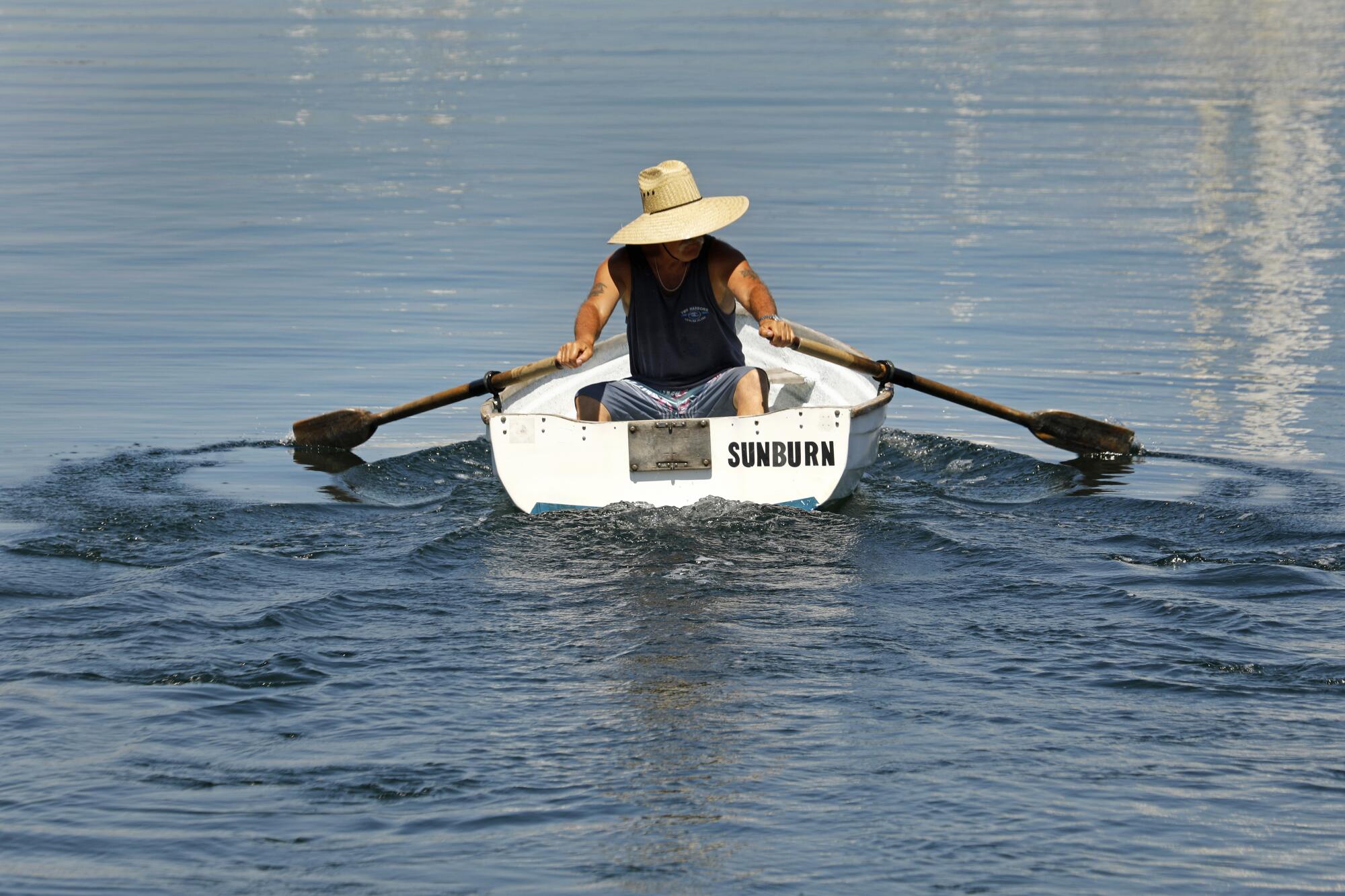 Bill Morris of Wilmington takes his dinghy for a paddle at Cabrillo Way Marina on Labor Day.