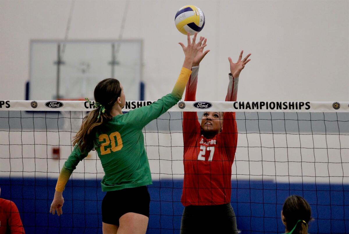 Mater Dei’s Isabel Clark tries to block a tip attempt by Mira Costa's Bryn Shankle on Saturday night.