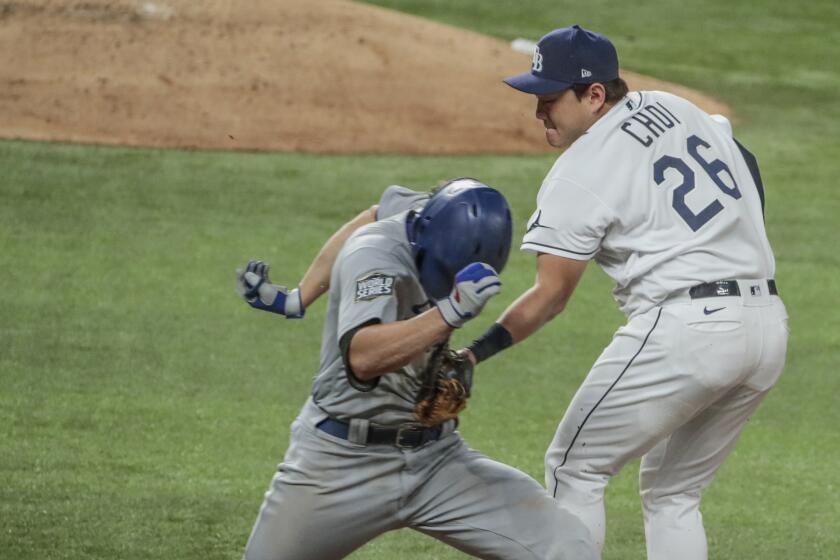 Dodgers' Corey Seager is tagged out by Rays first baseman Ji-Man Choi on a groundout in Game 3 of the World Series.