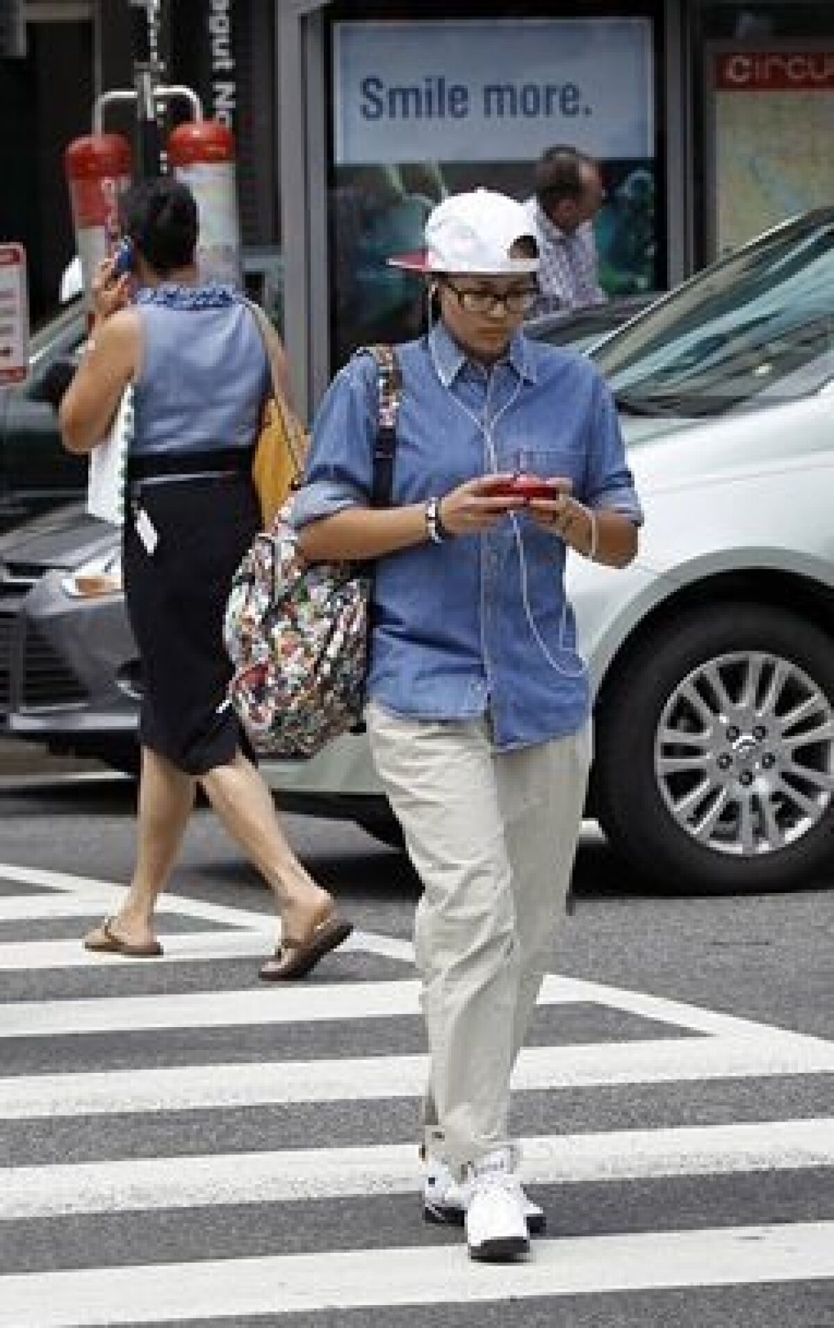 Two Washington D.C. pedestrians appear to be focusing on their phones more than their situation around them. (AP Photo/Pablo Martinez Monsivais)