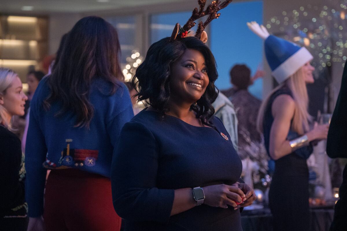 Octavia Spencer smiles while surrounded by other partygoers in the film "Spirited."