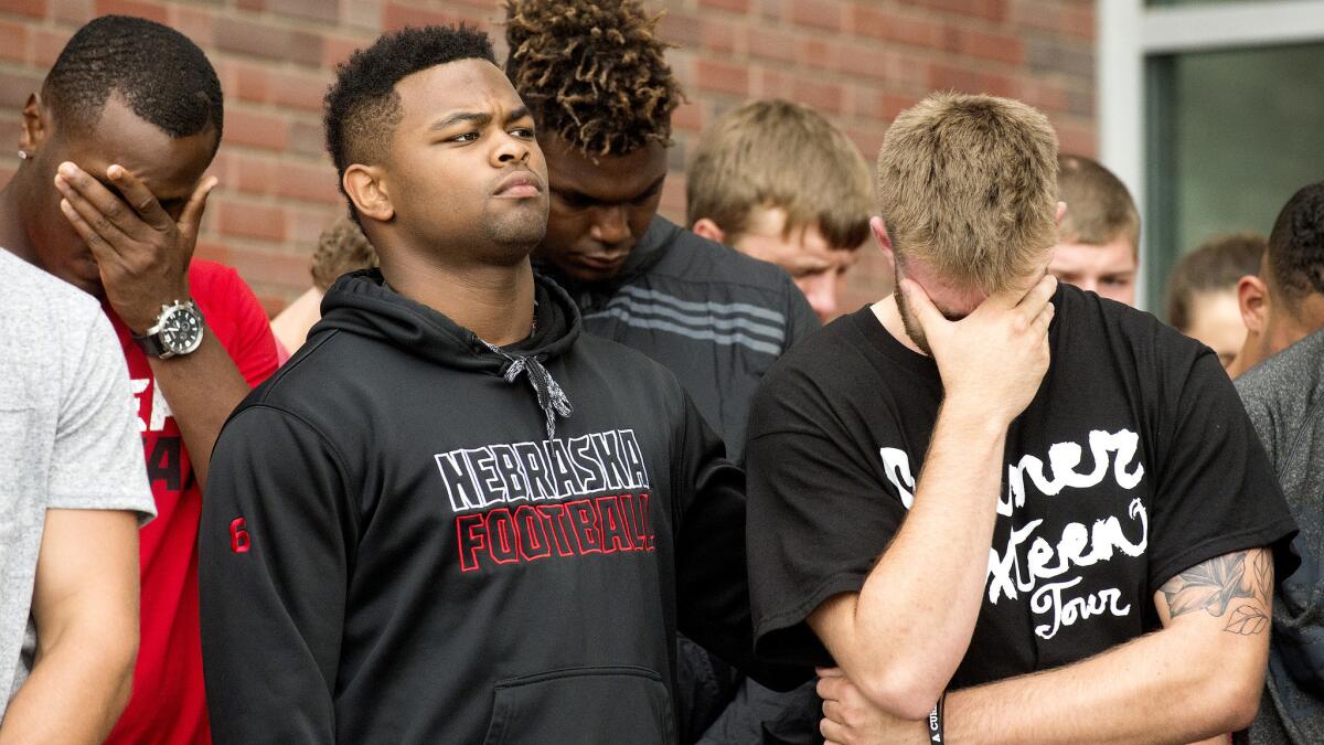Nebraska football players attend a vigil for teammate Sam Foltz, who died in a car crash Sunday along with former Michigan State punter Mike Sadler.