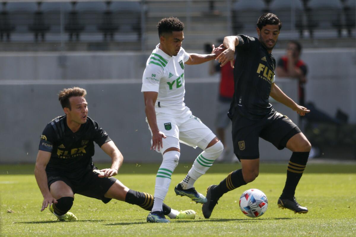LAFC forward Carlos Vela, right, vies for the ball with Daniel Pereira Gil on April 17 at Banc of California Stadium.