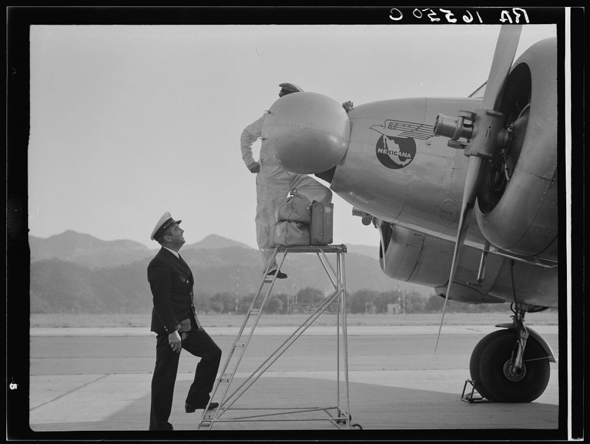 A plant quarantine inspector examines a plane at the Glendale Airport in 1937.